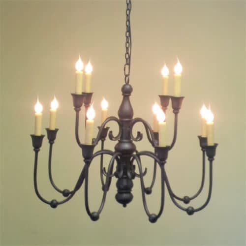 A stunning wrought iron chandelier featuring delicate curved arms and candle-like lights. The design showcases intricate detailing, providing a warm and welcoming ambiance, perfect for adding elegance to any space.
