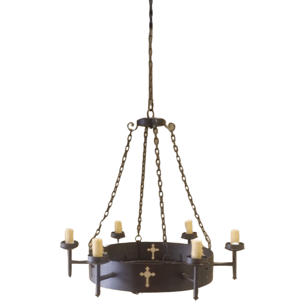 A handcrafted wrought iron chandelier features a circular frame with six candle holders, adorned with decorative crosses. It hangs from an intricately linked chain, combining elegance and rustic charm, perfect for enhancing any interior space.