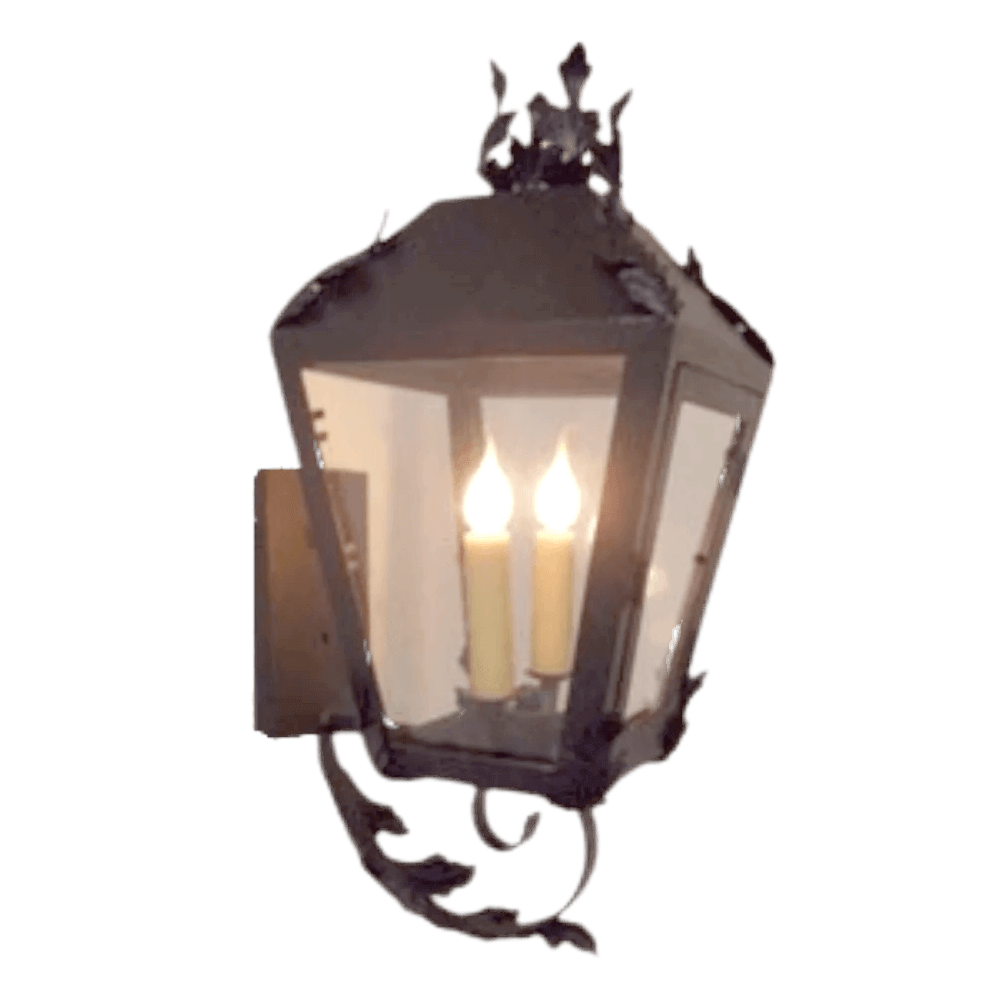 A beautifully crafted wrought iron wall sconce featuring a lantern-style design with two candle-style lights inside. The fixture is adorned with intricate floral details and has a charming black finish, ideal for adding warmth and elegance to any space.