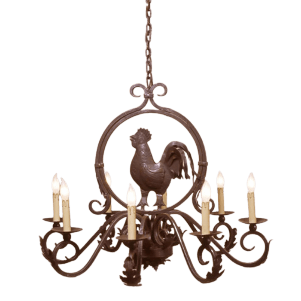 A decorative wrought iron chandelier featuring a central rooster motif surrounded by elegant scrollwork. It has six candle-style lights, each warmly illuminated, showcasing intricate craftsmanship and rustic charm, perfect for enhancing any space's character.