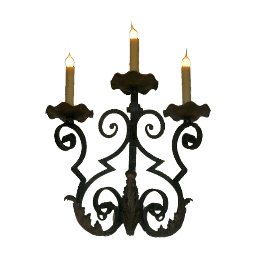 A decorative wrought iron sconce featuring intricate scrollwork and three candle holders, each topped with a scalloped base. The design exudes elegance and warmth, perfect for enhancing any interior space.