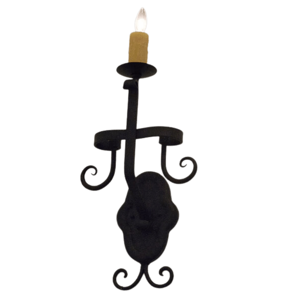 A decorative wall sconce featuring elegant curves and a candle holder design. The piece is crafted from wrought iron, showcasing a rustic charm perfect for adding warmth and ambiance to any space.