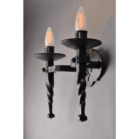 Two-candle wall sconce featuring a twisted design and metal accents, emitting a warm glow. Ideal for adding rustic elegance to any space.