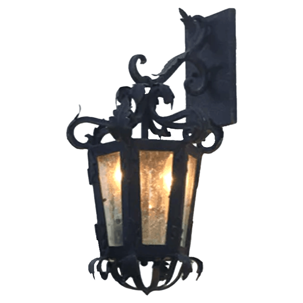 A decorative wall sconce featuring intricate wrought iron detailing, lantern-style design, and a warm glow emanating from three light bulbs.