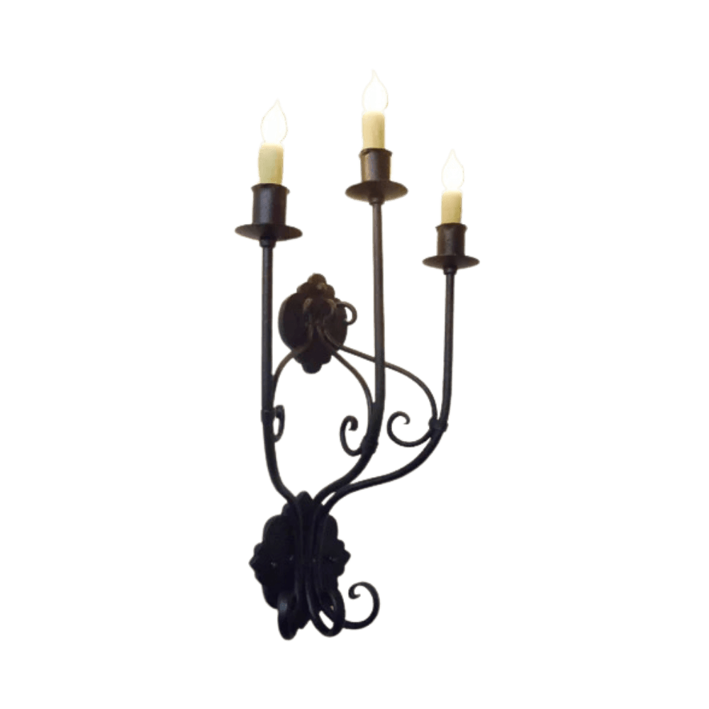 Three-arm wall sconce featuring elegant wrought iron design with intricate scrollwork and decorative accents. Each arm holds a candle-style light, providing warm illumination.