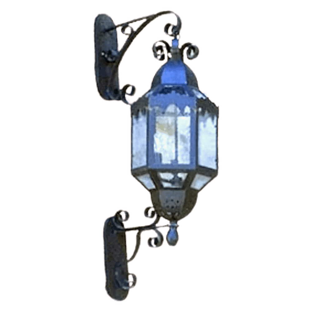 A decorative wall sconce featuring a glass shade with ornate wrought iron accents, perfect for adding character to any space.