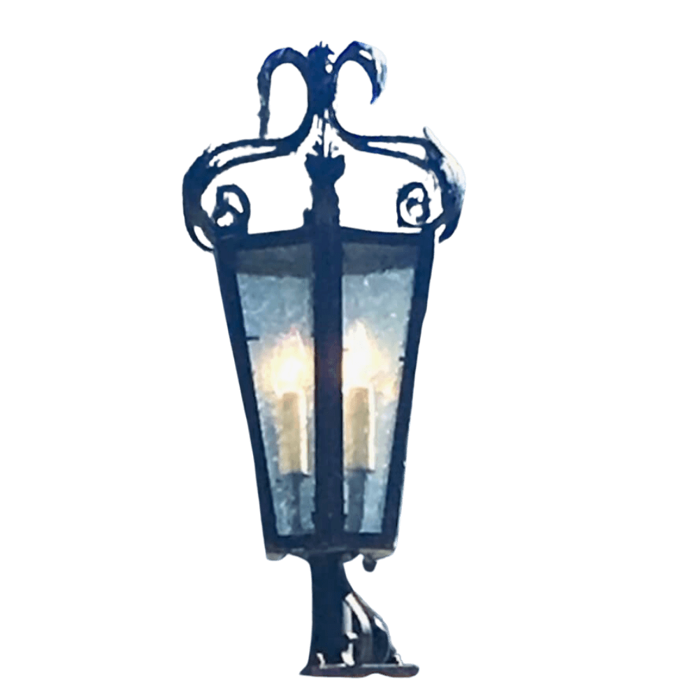 Elegant wrought iron sconce featuring intricate scrollwork and a glass enclosure, illuminating three bulbs for a warm ambiance. Perfect for adding a touch of vintage charm to any space.