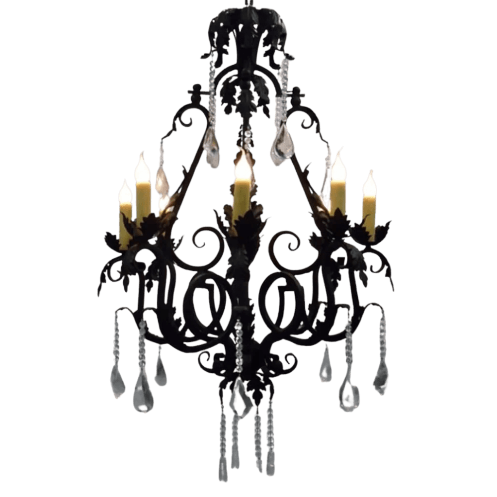 An elegant wrought iron chandelier featuring ornate scrollwork, six candle-like lights, and crystal accents that cascade gracefully, adding a touch of sophistication to any space.