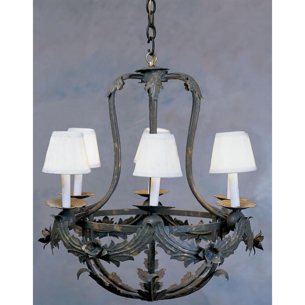 A decorative wrought iron chandelier featuring four candle-like fixtures with soft white shades, embellished with intricate leaf motifs.