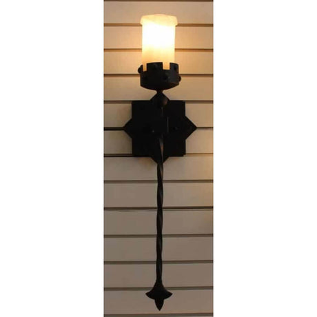 A decorative wall-mounted sconce featuring a twisted iron stem and a sculpted candle holder. The warm, glowing candle emits a soft light, enhancing the intricate design of the fixture. The black iron finish provides a rustic charm, perfect for adding character to any space.