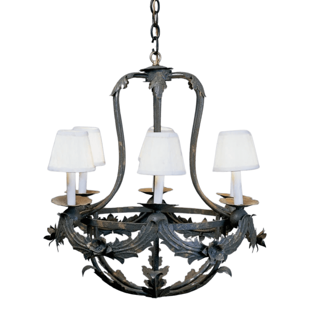 A beautifully crafted wrought iron chandelier featuring elegant leaf detailing and four light sources. The design is complemented by white fabric lampshades, adding a touch of sophistication. Perfect for enhancing any space with its artistic flair.