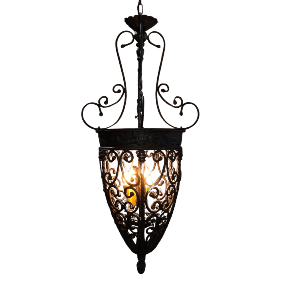 A beautifully crafted wrought iron pendant features intricate swirling designs and a warm glowing light source. The elegant shape enhances any space with its vintage charm.