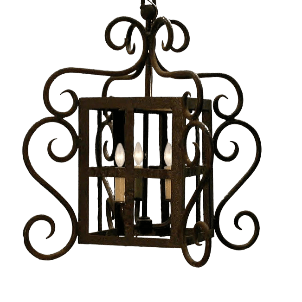 This ornate pendant features intricate wrought iron design with elegant curves and scrollwork, housing four candle-like lights for a warm glow.