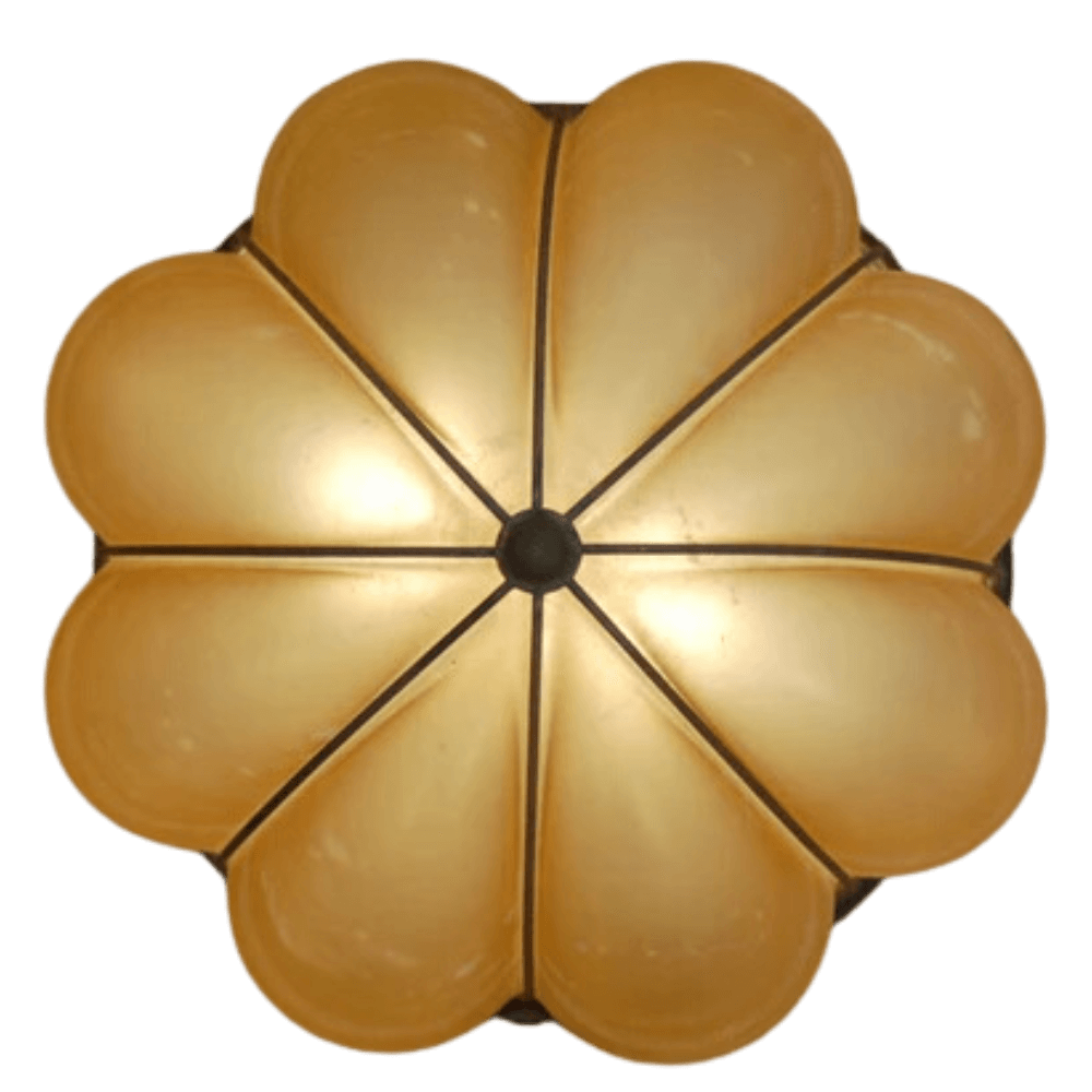 A round ceiling light fixture featuring a floral design with eight petal-like shapes, each in a warm, golden hue. The center is accented with a circular element, enhancing its elegant appearance, perfect for adding a touch of sophistication to any space.