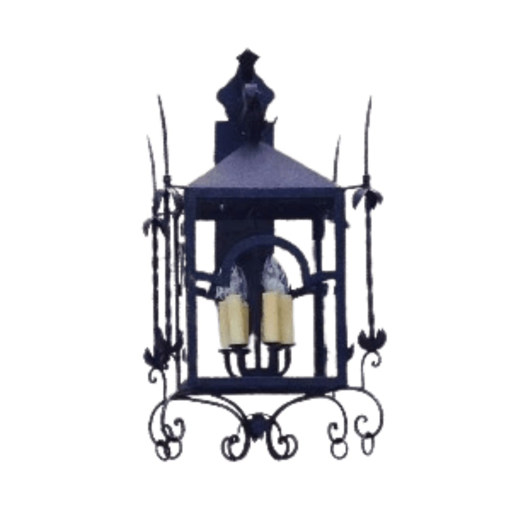 A decorative wrought iron sconce featuring two candle-style bulbs within an ornate frame. The design includes intricate scrollwork and a peaked top, ideal for adding warmth and elegance to any space.