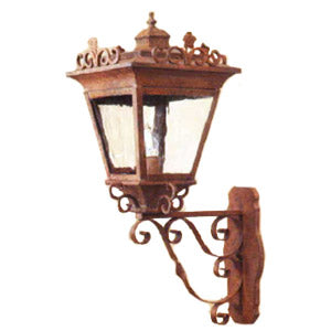 A beautifully crafted wrought iron wall sconce featuring intricate scrollwork and a glass lantern design. The fixture showcases a rustic finish, adding elegance and charm to any outdoor space.