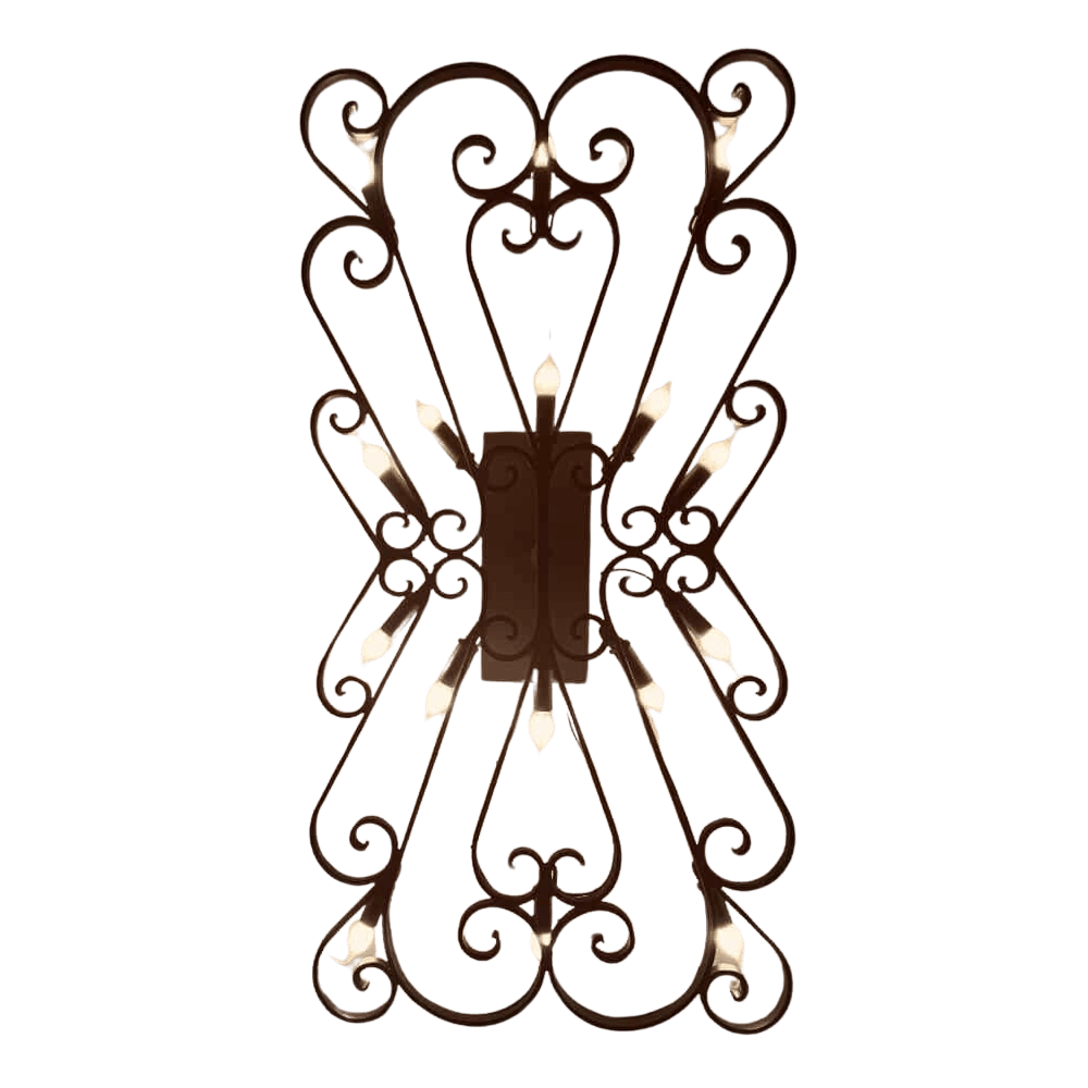A decorative wall sconce featuring intricate, swirling wrought iron design with multiple candle-like lights illuminating the ornate structure, adding warmth and elegance to any space.