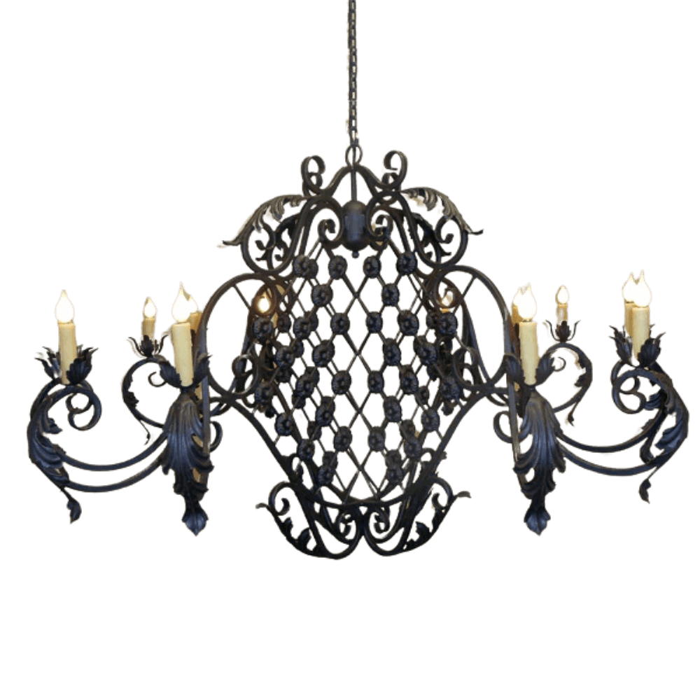 Elegantly crafted chandelier featuring intricate wrought iron designs, with eight candle-style lights. The ornate detailing and flowing curves add a touch of sophistication and warmth to any space.