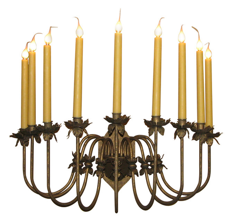A decorative wrought iron chandelier featuring ten elegant candle-shaped lights atop a curved design adorned with flower motifs. The warm, amber candles enhance the intricate craftsmanship, creating a timeless focal piece for any setting.