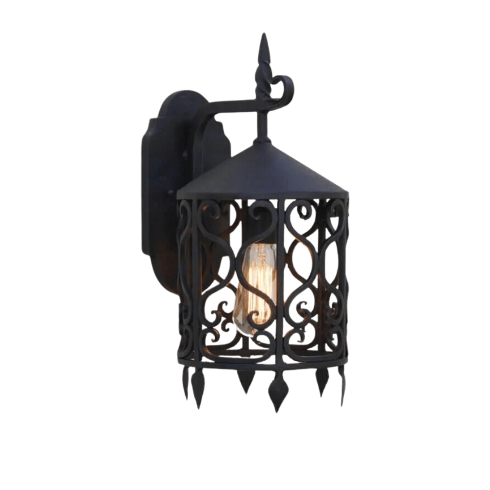 A beautifully crafted wrought iron sconce featuring intricate scrollwork and a pointed top. The design elegantly encases an exposed bulb, adding a touch of classic charm and warmth to any space.