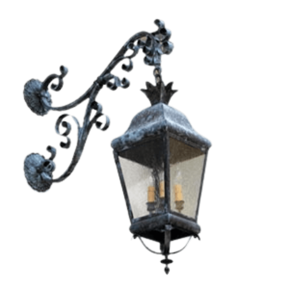 A wrought iron wall sconce featuring intricate scrolling details and a classic lantern shape. The fixture has a rustic finish and houses two light bulbs, offering a warm ambiance.