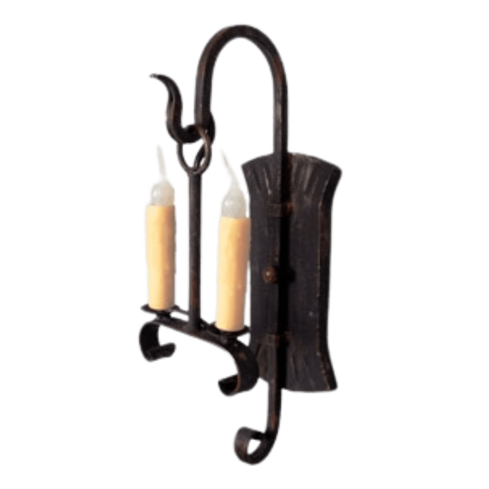 A handcrafted wrought iron wall sconce featuring two candle-style lights with a rustic finish. The elegant curves and detailed design add a warm, inviting ambiance to any space.