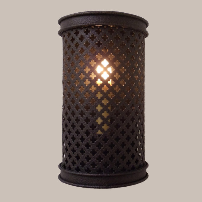 Wrought iron sconce featuring intricate perforations that create a stunning light effect. The elegant design adds warmth and sophistication to any space.