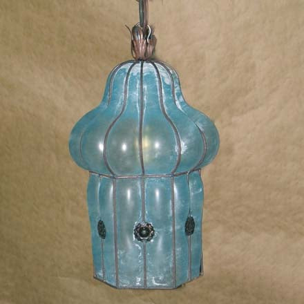 A unique pendant light featuring a curved, bulbous design with a distressed turquoise finish and decorative metal accents, ideal for adding a touch of elegance to any space.