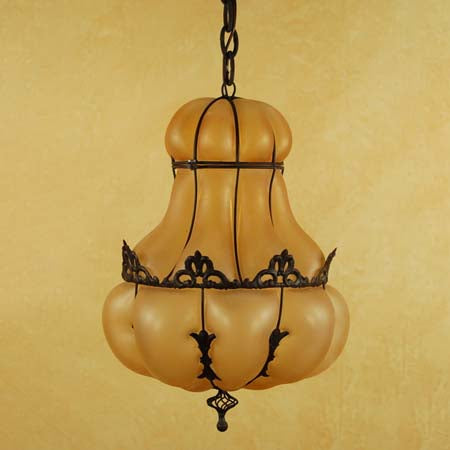 A beautifully crafted pendant light featuring a rounded amber glass shade, elegantly supported by intricate wrought iron detailing. The design combines classic elements with a warm glow, perfect for enhancing any indoor space.