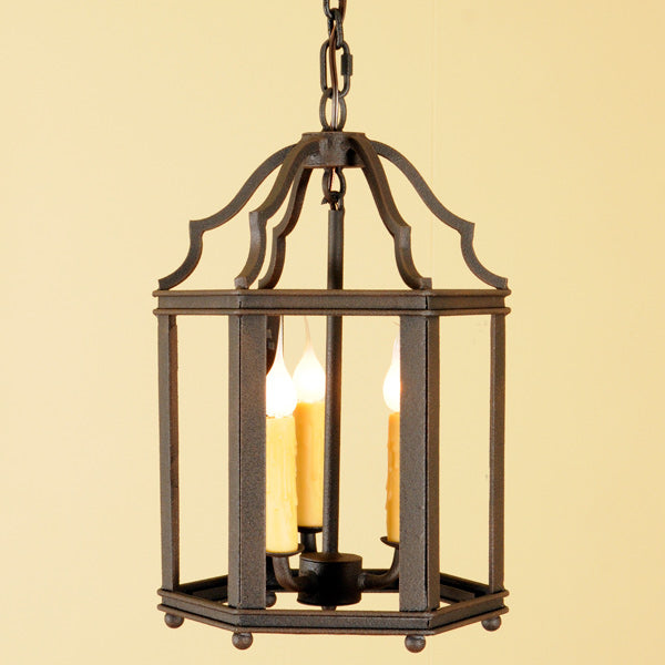 A decorative pendant light featuring an elegant wrought iron frame with scrollwork details. The fixture holds three candle-style lights with a warm, inviting glow, perfect for enhancing any room's ambiance.