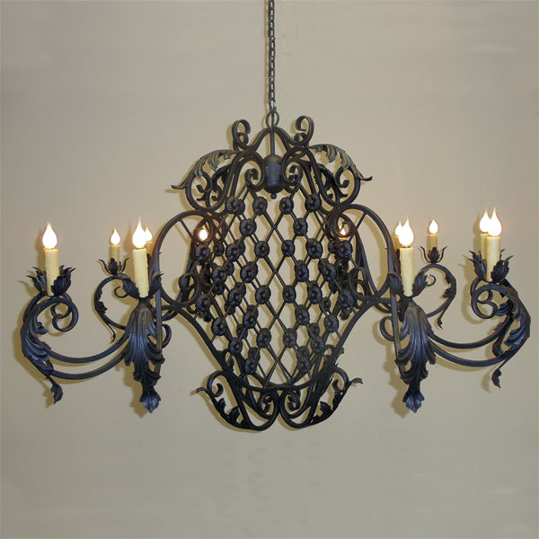This stunning chandelier features intricate wrought iron designs with ornate scrollwork and floral motifs. It includes multiple candle-like fixtures that add elegant illumination, perfect for enhancing any space with a timeless charm.
