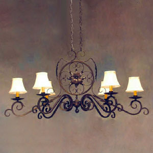 A decorative wrought iron chandelier featuring elegant curves and a central floral design. It includes five softly lit shades, adding a warm ambiance to the space. Perfect for enhancing any room with a classic touch.