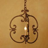 A decorative wrought iron chandelier featuring elegant scrollwork and a candle-style light, suspended by a chain against a warm, textured background.