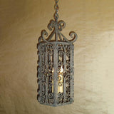 A beautifully crafted wrought iron pendant showcasing intricate scrollwork and a classic design. The fixture features a warm glow from the inner candle, adding elegance to any space.