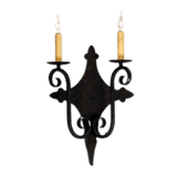 A decorative wrought iron sconce featuring two candle-style lights with warm yellow shades. The intricate design showcases elegant curves and details, perfect for adding a touch of charm to any space.