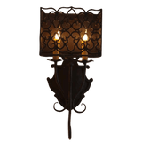 A decorative wall sconce featuring an intricate wrought iron design with a shaded lantern-style top. Two candle-style lights emit a warm glow, enhancing its elegant appearance. Perfect for adding a touch of sophistication to any interior space.