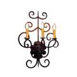 A decorative wall sconce featuring intricate swirls and curly accents, holding three candle-like bulbs. The rustic finish adds warmth and charm, perfect for enhancing entryways or living spaces.
