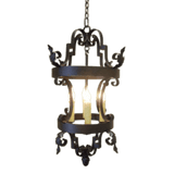 An ornate wrought iron pendant light featuring intricate scrollwork and a warm glow from candle-like bulbs inside. Perfect for adding elegance to any space.
