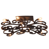 A decorative ceiling fixture featuring intricate wrought iron scrollwork, elegantly illuminating a space with multiple soft glowing bulbs, perfect for adding sophistication to any room.