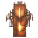A beautifully designed wrought iron sconce featuring a cylindrical shape with an intricate grid pattern, housing a warm, glowing light source in the center. The fixture combines elegance and artistry, perfect for enhancing any interior space.