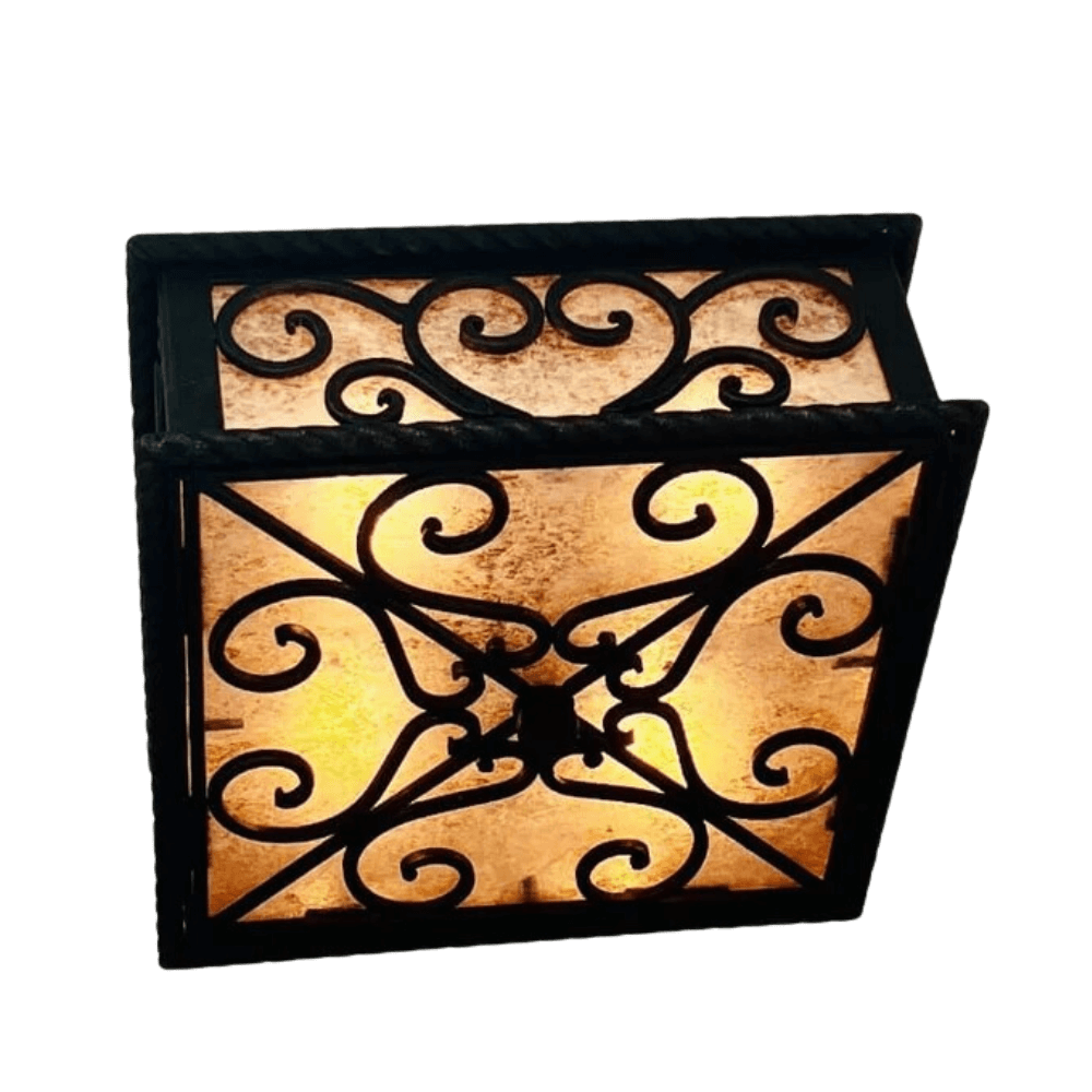 A decorative wrought iron sconce featuring intricate scrolling designs and a warm, glowing amber glass panel. Perfect for adding elegance to any space.