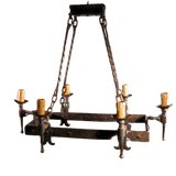 A beautifully crafted wrought iron chandelier featuring a rectangular frame with six candle holders. The design includes detailed, twisted chains and ornate accents, perfect for adding elegant illumination to any space.
