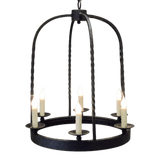 A stunning wrought iron chandelier featuring a circular design with five elegant candle holders. The intricate detailing and rustic finish enhance its charm, making it a perfect centerpiece for any room.