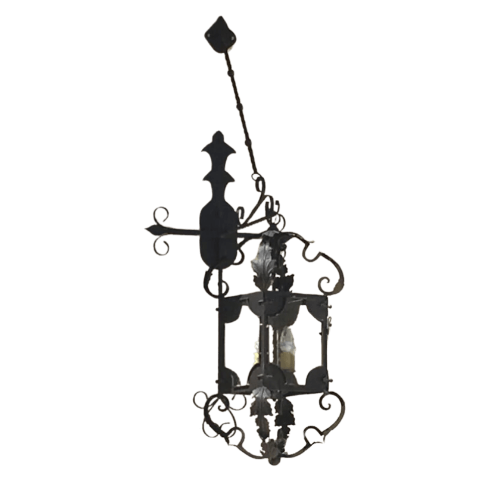 Elegant wrought iron pendant featuring intricate scrollwork and leaf motifs, complementing two light fixtures inside. Ideal for adding rustic charm.