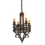 A decorative wrought iron chandelier featuring intricate scrollwork and five candle-style lights. The fixture combines rustic charm with elegance, suitable for enhancing any indoor space.