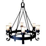 A beautifully crafted wrought iron chandelier featuring six candle-like fixtures, each illuminated with soft, glowing light. The design showcases elegant curves and intricate details, creating a warm and inviting ambiance suitable for various settings.