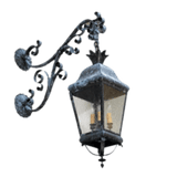 A wrought iron wall sconce featuring intricate scrolling details and a classic lantern shape. The fixture has a rustic finish and houses two light bulbs, offering a warm ambiance.