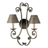 A decorative wall sconce featuring two elegant, curved arms supporting conical shades. The intricate scrolling design adds artistic flair, creating a warm and inviting ambiance perfect for enhancing interior spaces.