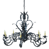 A beautifully crafted wrought iron chandelier featuring intricate leaf designs and six elegant candle holders. The dark finish enhances its ornate detailing, creating a stunning centerpiece for any space.