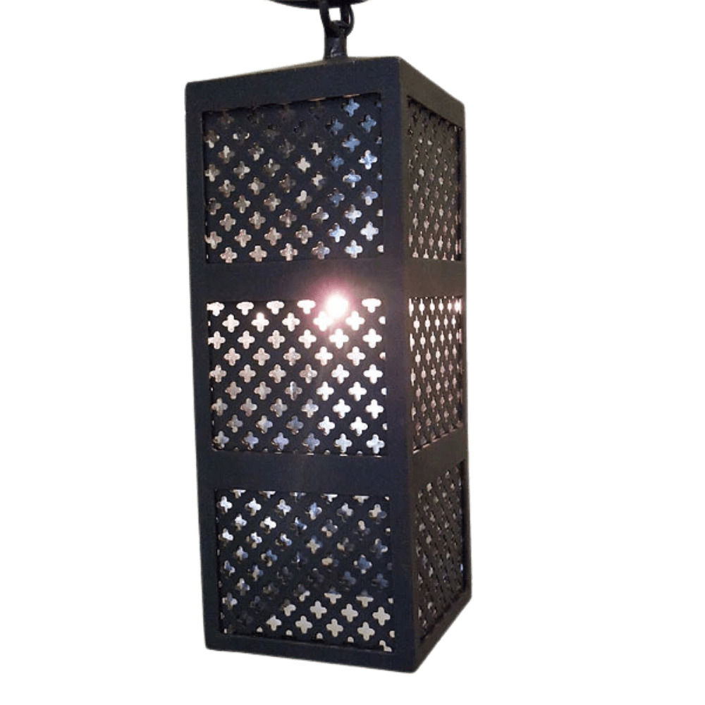 A beautifully designed wrought iron pendant light featuring intricate cutout patterns, allowing light to filter through in a captivating manner. The fixture has a sturdy rectangular shape, ideal for adding warmth and character to any space.
